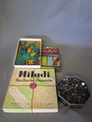 2 childs jigsaws, a set of Stak-a-stick game, a needlework set,  seal and a collection of marbles