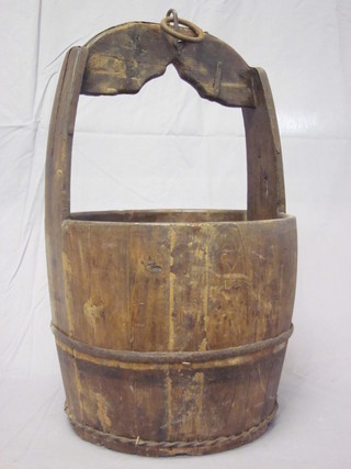 A wooden and iron well bucket