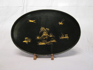 An oval Oriental black painted tea tray decorated birds 22"