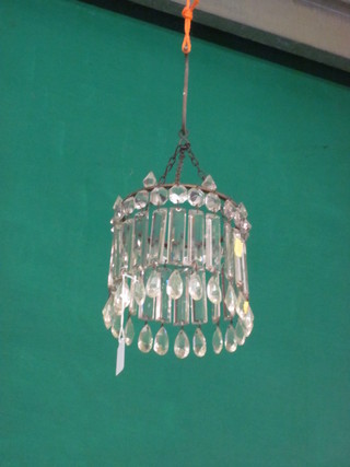 A circular hanging light shade hung cut glass lozenges
