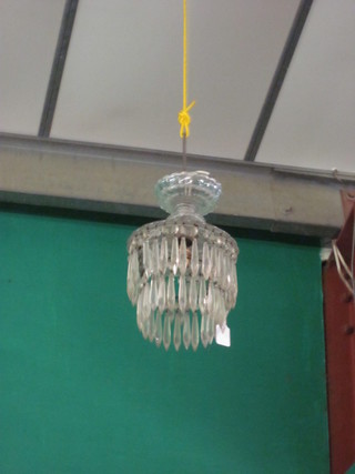A circular glass electrolier hung lozenges