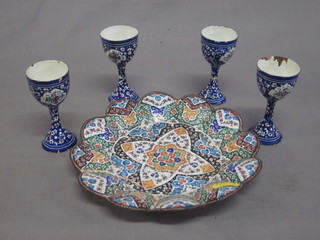 A Persian circular enamelled dish 8" together with 4 egg cups,  some chips,