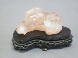 An Oriental rose coloured hardstone figure of a reclining horse  3", f,