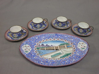 A Persian oval twin handled enamelled tray decorated a bridge  with dam 9" together with 4 miniature cups and saucers