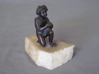 A bronze figure of a kneeling boy, raised on a marble base 3"
