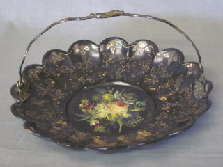 A Victorian circular black papier mache dish with floral  decoration and gilt metal swing handle in the form of 2 entwined  serpents 10"