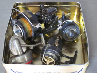 A large Surfcast multiplying fishing reel, f, and 3 others