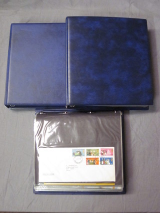 3 blue plastic loose leaf albums of first day covers and  presentation stamps