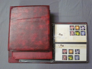 3 red plastic loose leaf albums of first day covers