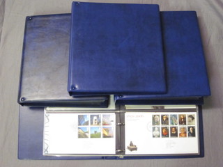 4 blue loose leaf albums of first day covers and presentation  stamps