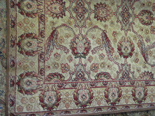 A cream ground and floral patterned carpet 123" x 90"