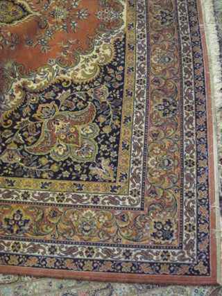 A peach and floral patterned Axeminster Persian style carpet 138" x 98"