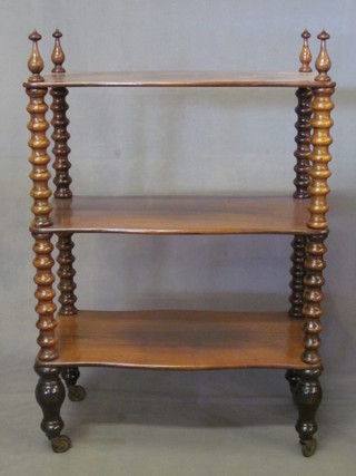 A Victorian shaped rosewood 3 tier what-not, raised on bobbin  turned supports 25"  ILLUSTRATED