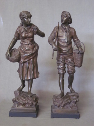 A pair of spelter figures of standing lady and gentleman gardeners, raised on square bases 18"