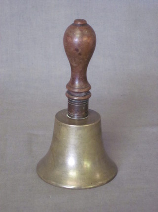 A small brass hand bell with turned wood handle