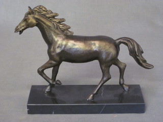 A cast bronzed figure of a horse on a marble base
