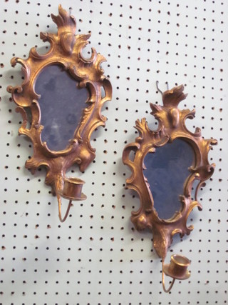 A pair of Rococo style plate mirrors contained in gilt frames with candle sconces 12"