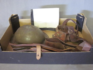 A steel helmet, 2 pistol holsters, a Sam Browne belt and a hand  written journal accounting military transport from India circa  1909