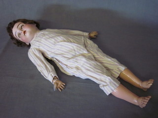 A porcelain doll with open and shutting eyes, open mouth and articulated body, the head incised 192