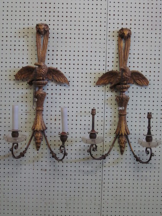 A pair of 19th Century gilt painted carved wooden wall light brackets decorated eagles 23"