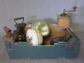 A coffee grinder, 3 old flat irons, an iron shoe last, an iron stand  and 2 Cibie head lamps