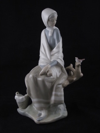 A LLadro figure of a seated lady with basket and small bird 10"