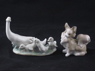 A Lladro figure of a seated dog 2" and a do. Geese 4 1/2"