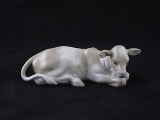 A Lladro figure of a seated cow 6"