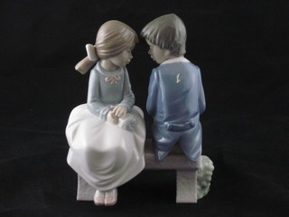 A Nao figure group of a seated boy and girl 6"