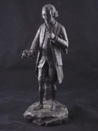 A Wedgwood black basalt figure of a standing 18th Century  gentleman, the base marked Wedgwood, chips to tail coat, 11"