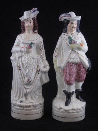 A Staffordshire figure of a standing gentleman with bird 9 1/2"  and 1 other of a lady with bird 10", f and r,