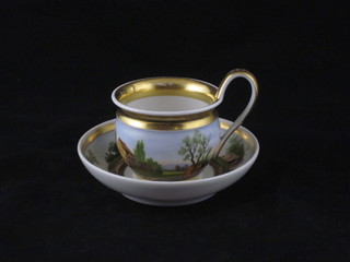A Continental porcelain cabinet cup and saucer decorated a figure  by a building and with gilt banding