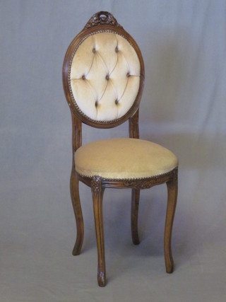 A Victorian style high backed salon chair upholstered in buttoned mushroom coloured material, raised on cabriole supports