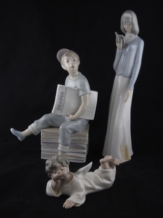 A Lladro figure of a reclining Angel 5", a Nao figure of a boy newspaper seller and 1 other Spanish figure of a standing lady