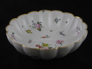 A Delft style circular porcelain bowl with floral decoration and scalloped border 11", cracked,