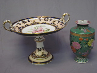 A circular porcelain twin handled with gilt and floral decoration 11" and a green glazed Oriental vase 8"