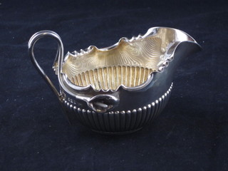 An Edwardian circular silver cream jug with demi-reeded  decoration, Sheffield 1900, by James Dixon, 2 ozs