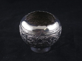 A circular embossed white metal vase of globular form,  base marked silver
