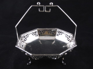 A pierced silver plated octagonal dish with swing handle, raised  on hoof feet by Mappin & Webb