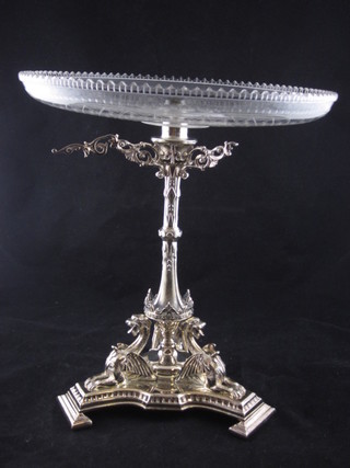 A silver plated table centre piece raised on a triform base  supported by 3 griffins with outswept brackets, 2 f, and having a  cut glass bowl to the centre  ILLUSTRATED