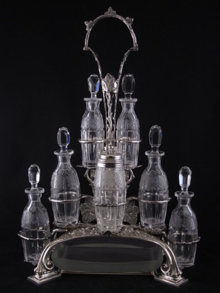A handsome 19th Century Continental silver plated and glass  bottle cruet, having a glass butter tray to the base and 8 glass  bottles  ILLUSTRATED