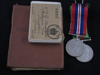 A pair of medals to 765129 Sgt. David Gordon Buckell REME, comprising British War medal and Victory medal together with a  soldier's pay book and other documents