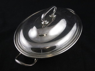 An oval silver plated twin handled entree dish and cover  complete with liner