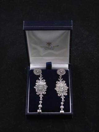 A pair of silver drop earrings