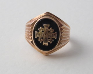 A gold signet ring decorated a Jerusalem cross