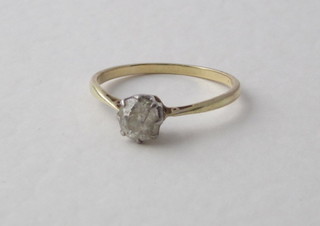 A gold dress ring set a solitaire diamond