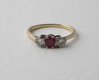 A lady's 18ct yellow gold dress ring set a ruby and 2 diamonds