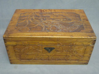 An Oriental carved camphor box with hinged lid, carved a  dragon 18"