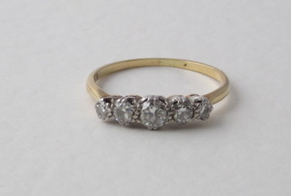 A lady's gold dress ring set 4 circular diamonds