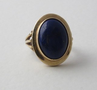 A 9ct yellow gold dress ring set a cabouchon cut blue stone